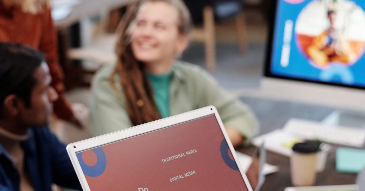Business team reviewing a presentation on a laptop in an office