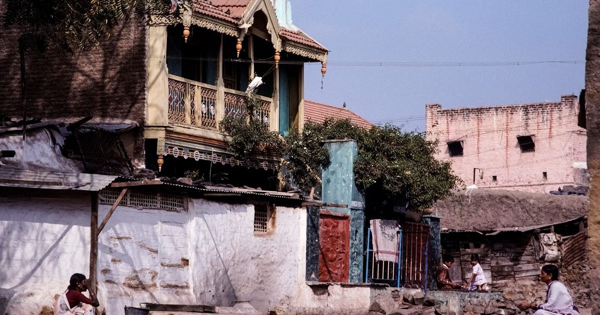 Residential street in an Indian town with houses and residents